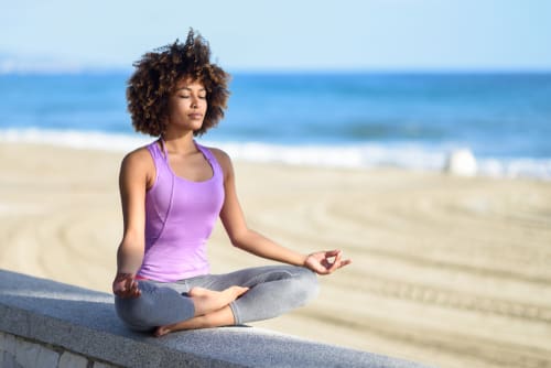 Woman practices mindfulness at the beach